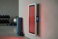 Side view of wall-mounted red light therapy panel in home wellness room
